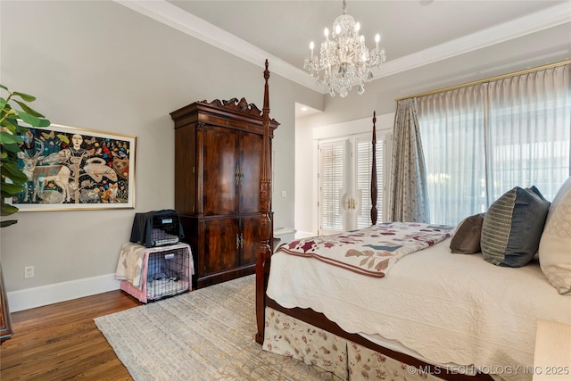 2524 E 66th Pl, Tulsa, OK 74136 - bedroom featuring wood finished floors, a chandelier, ornamental molding, and access to outside
