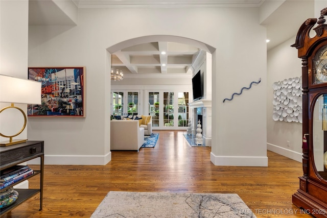 2524 E 66th Pl, Tulsa, OK 74136 - entrance foyer featuring ornamental molding, coffered ceiling, wood finished floors, beam ceiling, and arched walkways