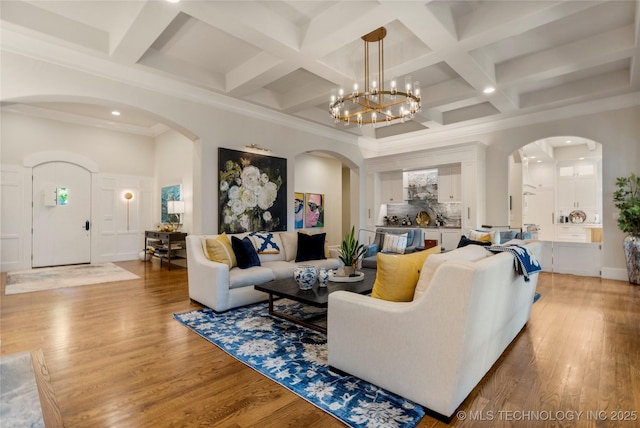 2524 E 66th Pl, Tulsa, OK 74136 - living room featuring arched walkways, coffered ceiling, recessed lighting, wood finished floors, and beamed ceiling