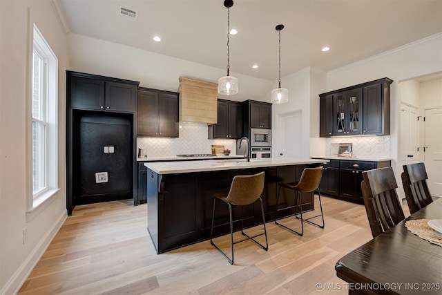 7117 E Queens St, Broken Arrow, OK 74014 - kitchen featuring appliances with stainless steel finishes, tasteful backsplash, light countertops, healthy amount of natural light, and recessed lighting