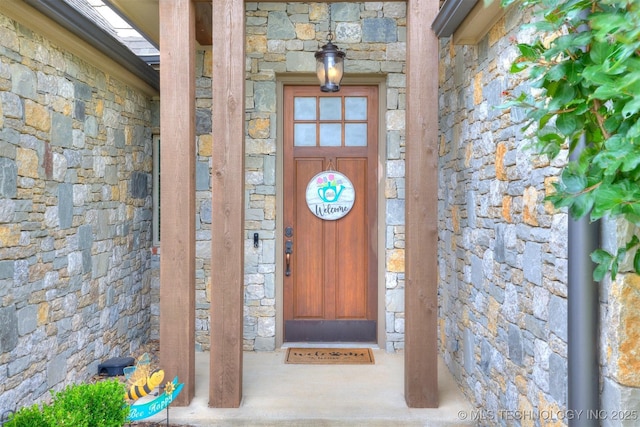 5509 E 121st Pl S, Tulsa, OK 74008 - view of exterior entry featuring stone siding