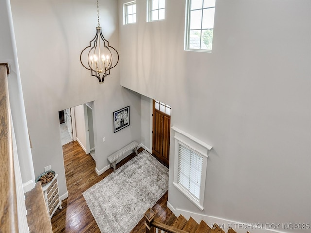 5509 E 121st Pl S, Tulsa, OK 74008 - foyer entrance featuring a chandelier, a high ceiling, and dark wood-style flooring