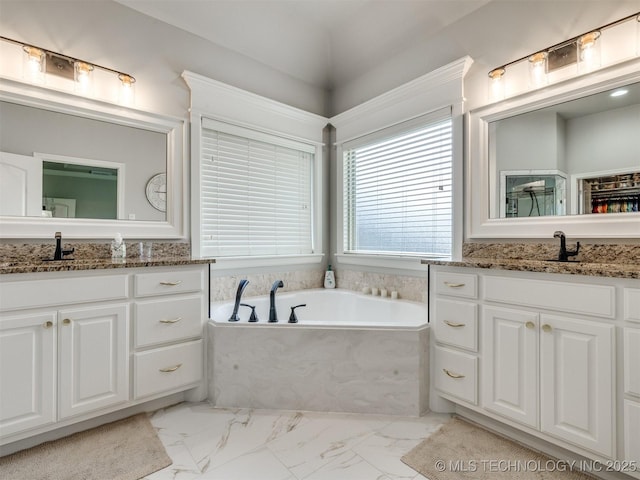5509 E 121st Pl S, Tulsa, OK 74008 - bathroom featuring two vanities, marble finish floors, and a bath