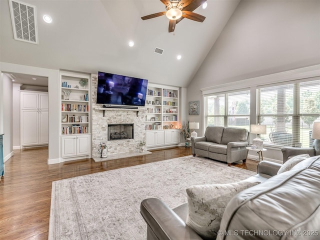 5509 E 121st Pl S, Tulsa, OK 74008 - living room with high vaulted ceiling, a fireplace, ceiling fan, recessed lighting, and wood finished floors