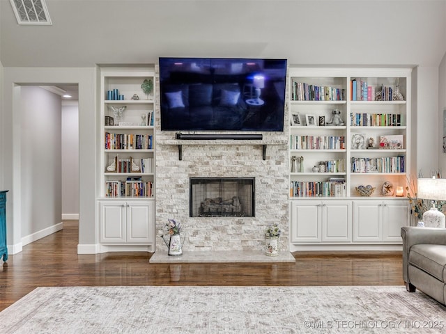 5509 E 121st Pl S, Tulsa, OK 74008 - living area featuring wood finished floors, a stone fireplace, and built in features