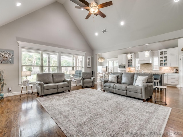 5509 E 121st Pl S, Tulsa, OK 74008 - living room with high vaulted ceiling, a ceiling fan, recessed lighting, and wood finished floors