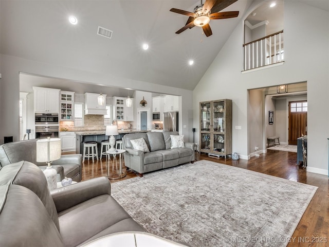 5509 E 121st Pl S, Tulsa, OK 74008 - living room with high vaulted ceiling, a ceiling fan, recessed lighting, and dark wood-type flooring