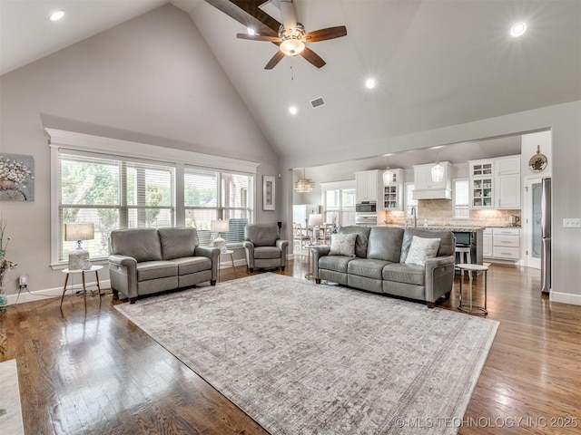 5509 E 121st Pl S, Tulsa, OK 74008 - living room with high vaulted ceiling, ceiling fan, recessed lighting, and wood finished floors
