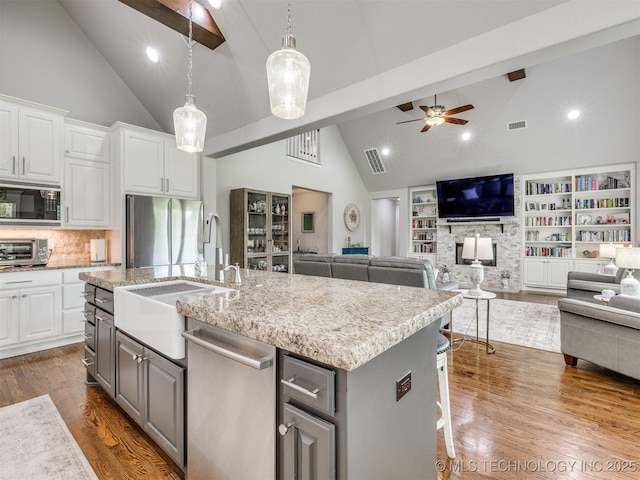 5509 E 121st Pl S, Tulsa, OK 74008 - kitchen with stainless steel appliances, a ceiling fan, high vaulted ceiling, open floor plan, and gray cabinetry