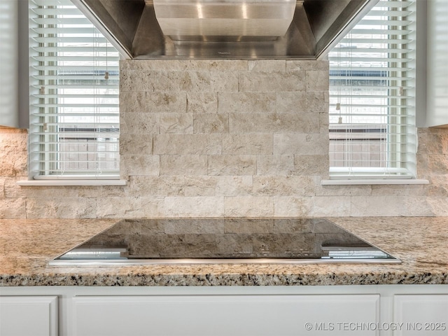 5509 E 121st Pl S, Tulsa, OK 74008 - kitchen view of tasteful backsplash, white cabinets, and range hood