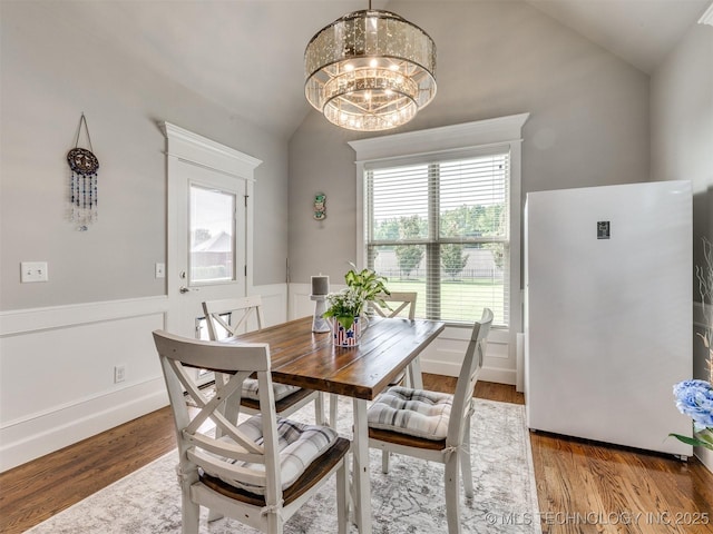 5509 E 121st Pl S, Tulsa, OK 74008 - dining area featuring lofted ceiling, a chandelier, and wood finished floors