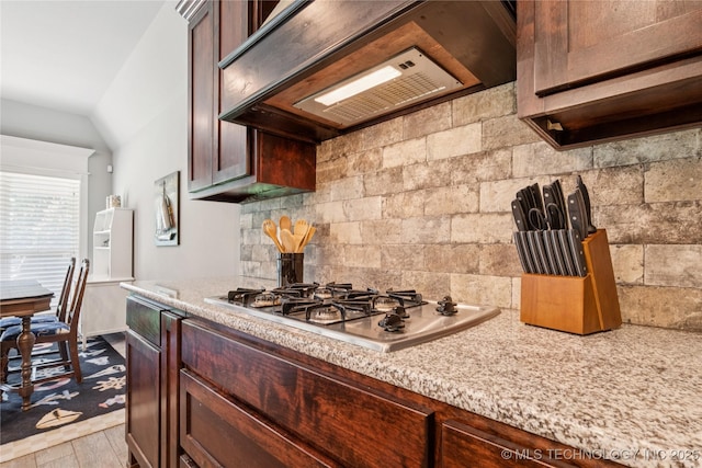 6904 S Chestnut Ave, Broken Arrow, OK 74011 - kitchen featuring stainless steel gas cooktop, decorative backsplash, range hood, wood finished floors, and lofted ceiling