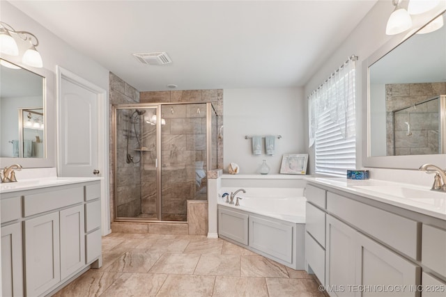 6904 S Chestnut Ave, Broken Arrow, OK 74011 - full bath with a shower stall, two vanities, and a garden tub