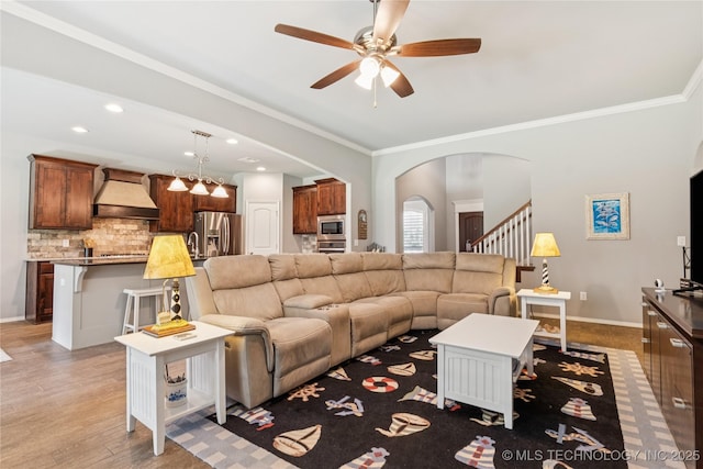 6904 S Chestnut Ave, Broken Arrow, OK 74011 - living area featuring a ceiling fan, arched walkways, crown molding, stairs, and wood finished floors