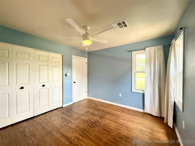 206 S 2nd St, Eufaula, OK 74432 - unfurnished bedroom with wood finished floors, a closet, and a ceiling fan