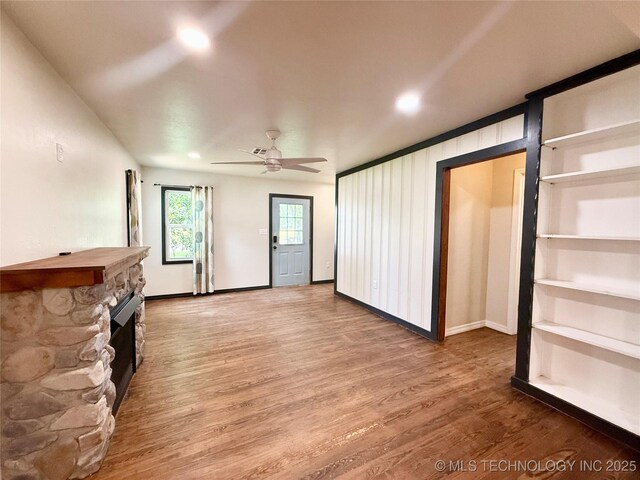 206 S 2nd St, Eufaula, OK 74432 - unfurnished living room featuring a fireplace, wood finished floors, ceiling fan, and recessed lighting