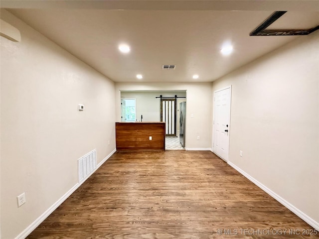 206 S 2nd St, Eufaula, OK 74432 - empty room featuring recessed lighting, wood finished floors, and a barn door