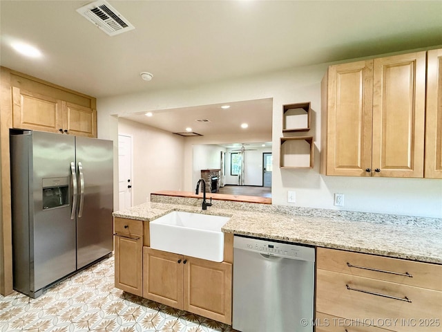 206 S 2nd St, Eufaula, OK 74432 - kitchen with appliances with stainless steel finishes, light brown cabinets, light stone countertops, recessed lighting, and a peninsula