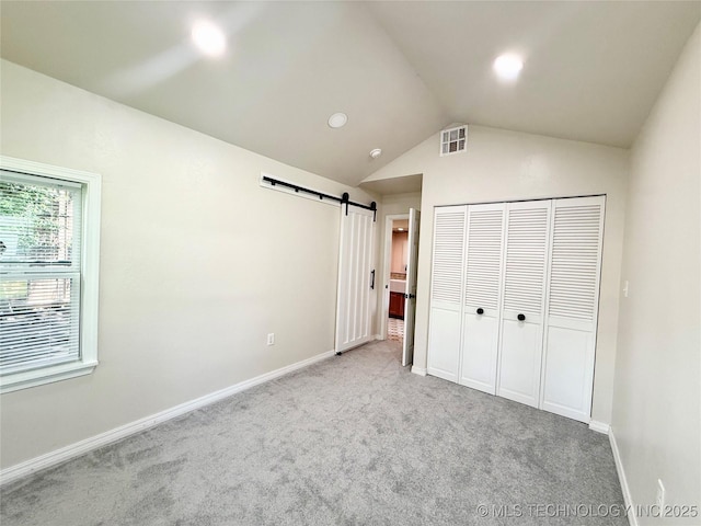 206 S 2nd St, Eufaula, OK 74432 - unfurnished bedroom with lofted ceiling, a barn door, carpet floors, a closet, and recessed lighting