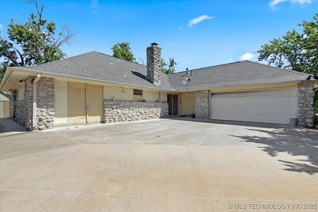 3329 S 93rd E Ave, Tulsa, OK 74145 - ranch-style house with stone siding, concrete driveway, and an attached garage