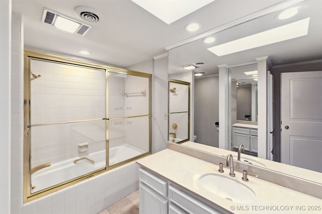 2151 E 27th St, Tulsa, OK 74114 - bathroom with recessed lighting, combined bath / shower with glass door, vanity, a skylight, and crown molding