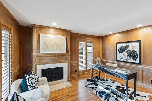 2151 E 27th St, Tulsa, OK 74114 - office space with light wood-style flooring, a premium fireplace, recessed lighting, wood walls, and a decorative wall
