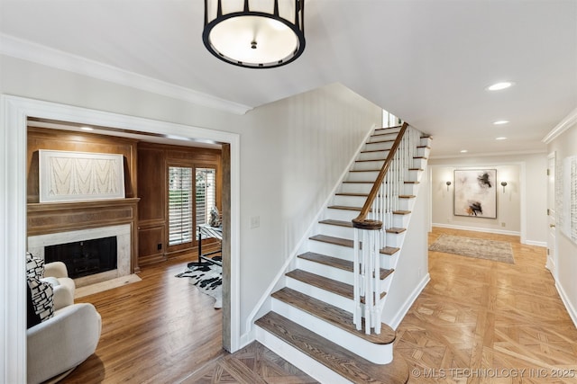 2151 E 27th St, Tulsa, OK 74114 - stairs with ornamental molding, a fireplace, and recessed lighting
