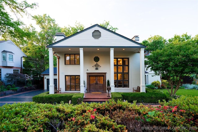 2151 E 27th St, Tulsa, OK 74114 - view of front facade featuring a chimney and covered porch