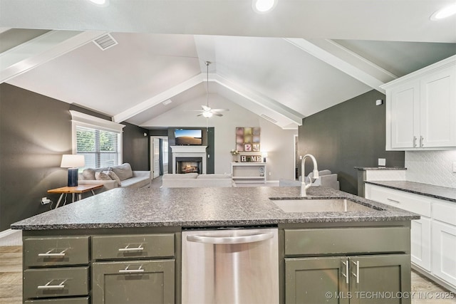 8035 Tims Ln, Claremore, OK 74019 - kitchen with dishwasher, a center island with sink, vaulted ceiling, white cabinetry, and open floor plan