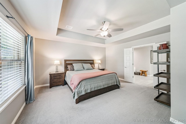 8035 Tims Ln, Claremore, OK 74019 - bedroom featuring light colored carpet, a raised ceiling, and ceiling fan