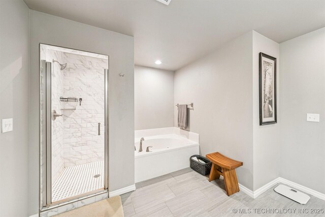 8035 Tims Ln, Claremore, OK 74019 - bathroom with a garden tub, a shower stall, and recessed lighting