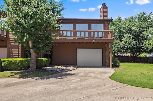 2807 E 90th St Unit 4, Tulsa, OK 74137 - view of front of home featuring an attached garage, driveway, board and batten siding, a chimney, and a front lawn