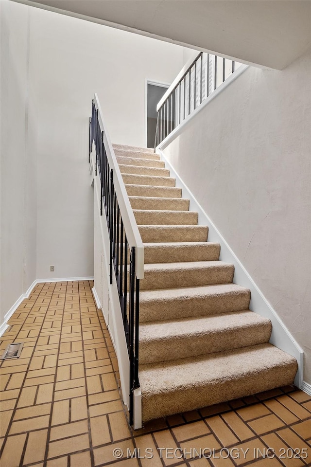 2807 E 90th St Unit 4, Tulsa, OK 74137 - stairway with brick floors and baseboards