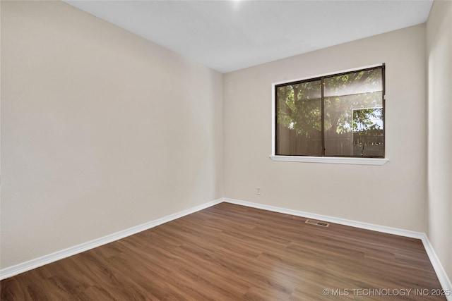 2807 E 90th St Unit 4, Tulsa, OK 74137 - empty room featuring baseboards and wood finished floors