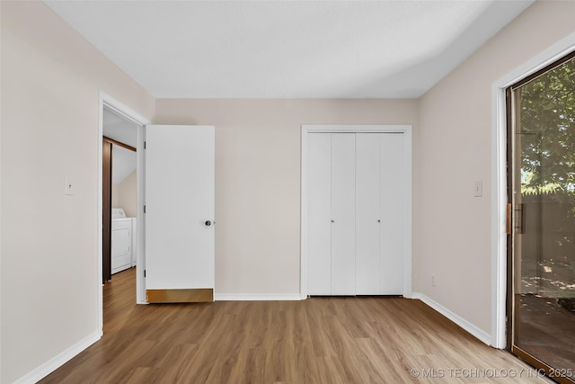 2807 E 90th St Unit 4, Tulsa, OK 74137 - unfurnished bedroom with wood finished floors, washer / dryer, and a closet