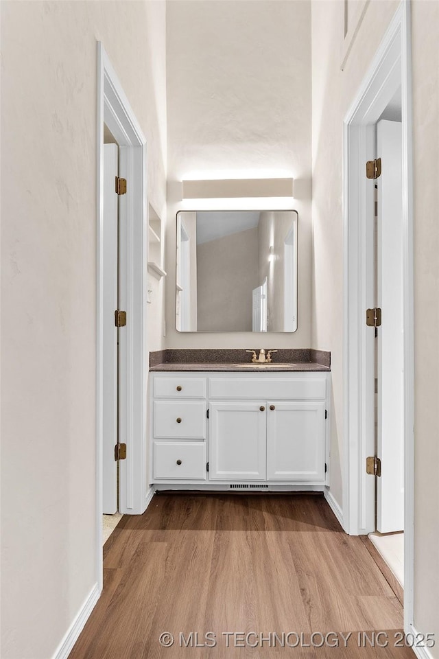 2807 E 90th St Unit 4, Tulsa, OK 74137 - bathroom featuring wood finished floors and vanity