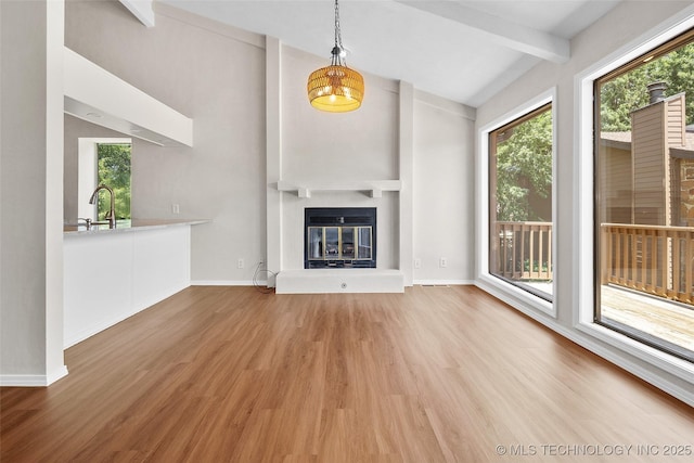2807 E 90th St Unit 4, Tulsa, OK 74137 - unfurnished living room featuring wood finished floors and a glass covered fireplace