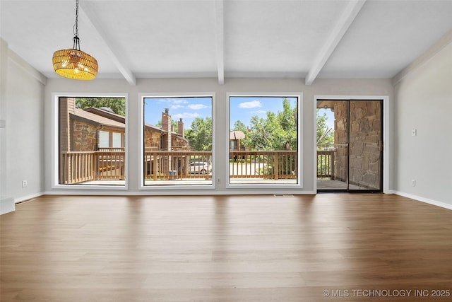 2807 E 90th St Unit 4, Tulsa, OK 74137 - unfurnished living room with wood finished floors and beamed ceiling