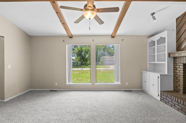 1121 S 221st W Ave, Sand Springs, OK 74063 - unfurnished living room with carpet floors, ceiling fan, beamed ceiling, and a fireplace