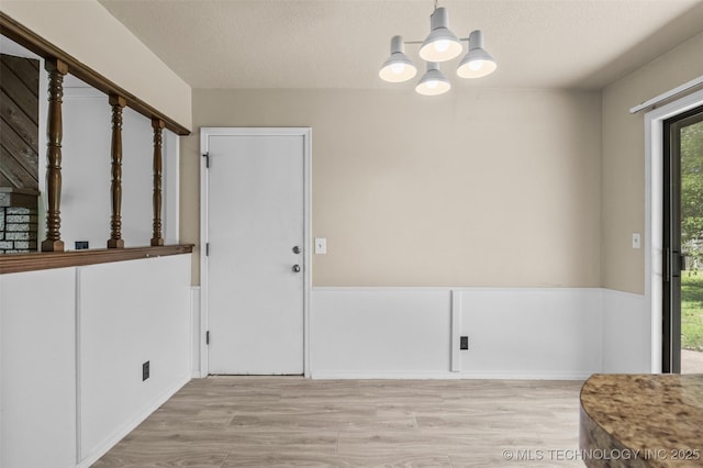 1121 S 221st W Ave, Sand Springs, OK 74063 - unfurnished dining area featuring wood finished floors, a chandelier, and a textured ceiling
