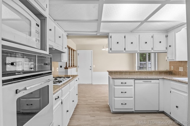 1121 S 221st W Ave, Sand Springs, OK 74063 - kitchen with white appliances, decorative backsplash, white cabinets, light countertops, and light wood finished floors