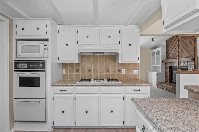 1121 S 221st W Ave, Sand Springs, OK 74063 - kitchen with white appliances, white cabinetry, decorative backsplash, and under cabinet range hood
