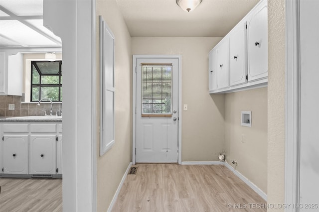 1121 S 221st W Ave, Sand Springs, OK 74063 - laundry room with light wood-type flooring, cabinet space, washer hookup, and gas dryer hookup