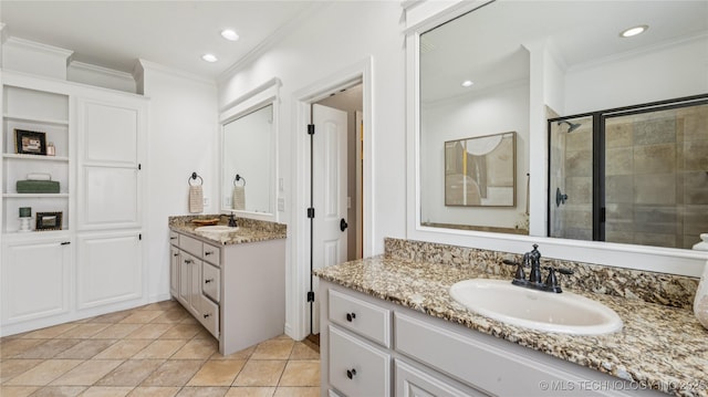 9198 E 120th St S, Bixby, OK 74008 - bathroom featuring crown molding, two vanities, a shower stall, tile patterned flooring, and recessed lighting