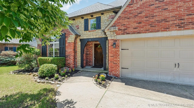 9198 E 120th St S, Bixby, OK 74008 - view of front of house featuring brick siding, concrete driveway, a garage, stone siding, and a shingled roof