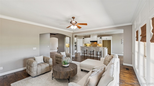 9198 E 120th St S, Bixby, OK 74008 - living room featuring arched walkways, ceiling fan, wood finished floors, and ornamental molding