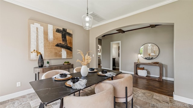 9198 E 120th St S, Bixby, OK 74008 - dining area featuring arched walkways, stone finish floors, and crown molding