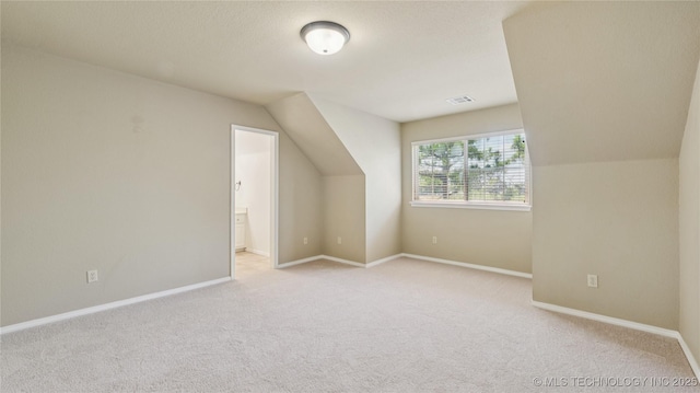 9198 E 120th St S, Bixby, OK 74008 - additional living space featuring light carpet and vaulted ceiling