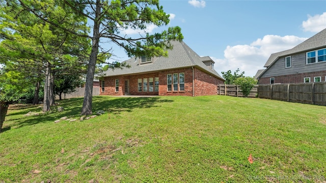 9198 E 120th St S, Bixby, OK 74008 - back of house with a fenced backyard and brick siding