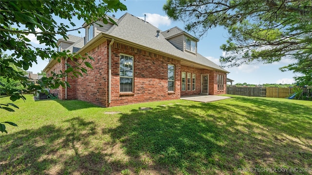 9198 E 120th St S, Bixby, OK 74008 - back of property with brick siding, a patio, a playground, and a shingled roof